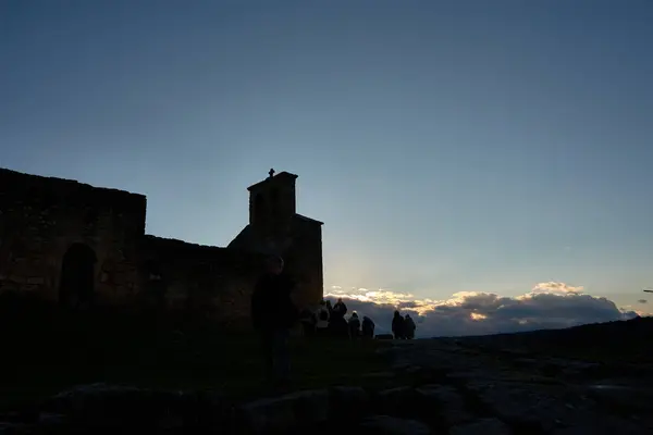 stock image Silhouette of the Church of Our Lady of the Castle with silhouettes of people in Castelo Mendo Portugal