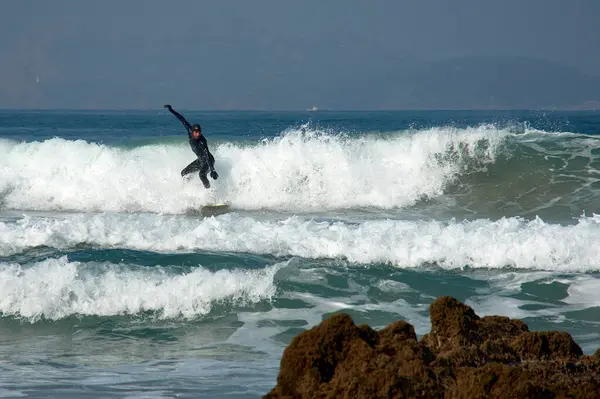 stock image Nigrn, Pontevedra, Spain; February,11,2022; surfer on Patos Beach with the Cies Islands in the background on a winter day