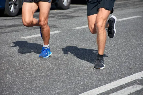 stock image The photograph highlights the determination and energy of the participants as they move through the course. Each stride tells a story of endurance, speed, and commitment, set against the backdrop of Baiona's streets.