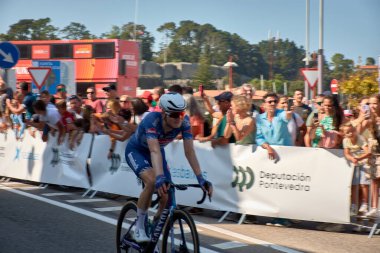 Bayona,Pontevedra,Spain; August,27,2024;thrilling moment as cyclists cross the finish line in Bayona during a stage of the Vuelta a Espaa. The atmosphere is electric with spectators cheering and the riders pushing through the final meters after a g clipart