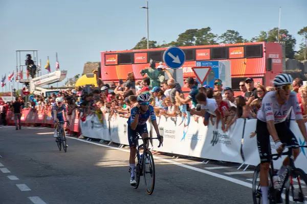 stock image Bayona,Pontevedra,Spain; August,27,2024;thrilling moment as cyclists cross the finish line in Bayona during a stage of the Vuelta a Espaa. The atmosphere is electric with spectators cheering and the riders pushing through the final meters after a g