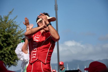 ayona,Pontevedra,Spain; August,27,2024;a street performance taking place in the charming streets of Bayona. The scene is filled with energy as performers engage the crowd with captivating acts, surrounded by the picturesque backdrop of historic build clipart