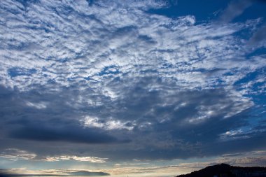 The breathtaking clouds at sunset over Playa America in Nigran, Spain. As the day comes to a close, the sky is filled with a dramatic blend of clouds illuminated by the warm hues of the setting sun clipart