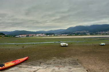 Low tide at the marisma da Foz with Sabaris in the background clipart