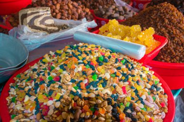 This closeup captures the vivid array of spices available at Chorsu Bazaar in Tashkent, Uzbekistan. The market is renowned for its rich display of colorful spices, ranging from deep reds to bright yellows and earthy browns.  clipart