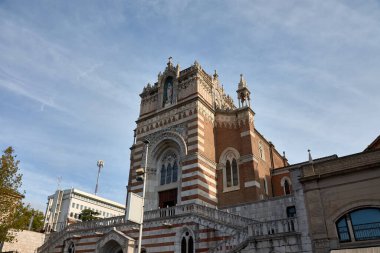Hırvatistan 'ın Rijeka kentindeki Our Lady of Lourdes' in Capuchin Kilisesi, neo-Gotik mimarinin çarpıcı bir örneği olarak duruyor. Bu görüntü kilisenin dış görünüşünü yansıtıyor, kırmızı tuğla ve taştan oluşan güzel çizgili cephesini vurguluyor.. 