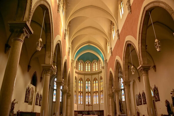 Elegant interior arches of the Capuchin Church of Our Lady of Lourdes, located in Rijeka, Croatia. The arches, designed in a neo-Gothic style, add a sense of grandeur and spiritual depth to the church's sacred space.  