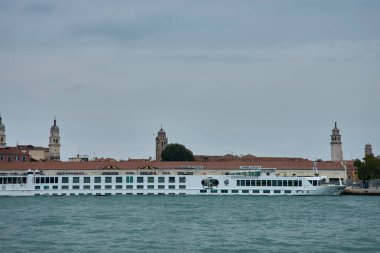 Venedik, İtalya; Ekim, 17. 2024: bulutlu bir günde Venedik kanalının melankolik güzelliği. Bulutlu gökyüzünden gelen yumuşak gölgeler sakin sulara ve kanalı çevreleyen tarihi binalara yavaşça düşerek sakin ve sakin bir atmosfer yaratıyor.