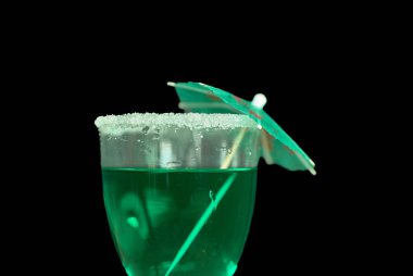 A stylish green liqueur served in a sugar-rimmed glass, enhanced with festive green decorations, and set against a deep black background. This image perfectly embodies the celebratory spirit of St. Patricks Day clipart