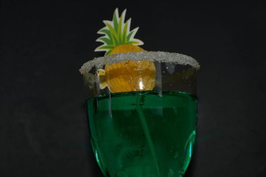 A stylish green liqueur served in a sugar-rimmed glass, enhanced with festive green decorations, and set against a deep black background. This image perfectly embodies the celebratory spirit of St. Patricks Day clipart