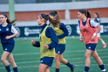 Vigo, Pontevedra,Spain;December,14,2024:A dynamic and focused moment during the warm-up of the Galician under-16 women's football team in the Spanish Championship held in Vigo.  clipart