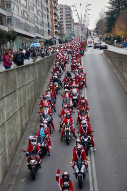 Vigo,Pontevedra,Spain December,21,2024:The Papanoelada motera in Vigo is an annual festive motorcycle parade where thousands of riders take to the streets dressed in creative Christmas-themed costumes.  clipart