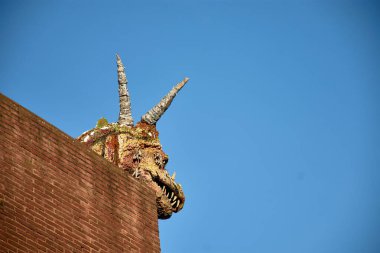 a majestic dragon head sculpture located in Cimadevilla, the oldest and highest neighborhood in Gijn, Spain. The artwork stands as a symbol of the areas rich cultural heritage and artistic flair.  clipart