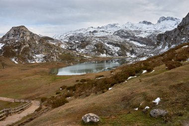 Lake Ercina, one of the famous Lakes of Covadonga in Asturias, Spain, is surrounded by breathtaking snow-capped mountains. This stunning alpine lake, located in the Picos de Europa National Park, offers a serene and picturesque winter landscape. clipart