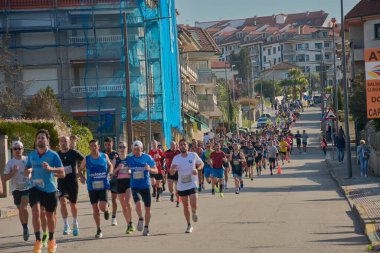 Nigran, Pontevedra, İspanya; 6 Nisan 2025; Bu yakın plan, İspanya 'nın Nigran kentinden geçerken yıllık Vigo-Bayona maratonuna katılan koşucuların enerjilerini ve kararlılıklarını yakalar. Fotoğraf yarışın şiddetini vurguluyor ve...
