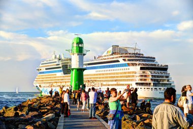 Warnemunde, Germany - September 21nd 2024 - Photo shows Cruise ships and a Ferry are leaving from Warnemuende. clipart