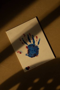 Blue and red hand prints on canvas symbolize a love that once was but is now just a painful memory etched in paint. clipart