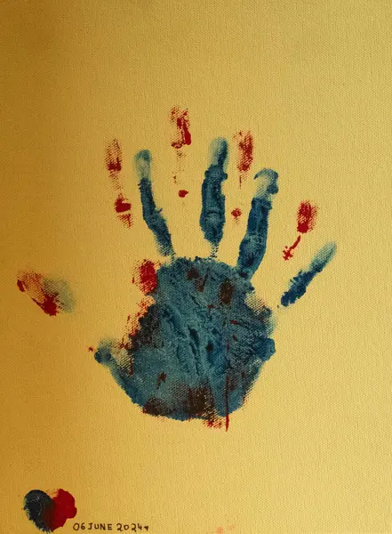 stock image The canvas captures the hand prints of a once cherished love, now a painful memory, each color speaking volumes of a story untold and a heartache too deep to forget.