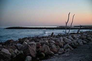 Deniz kıyısında gün batımının ışığında