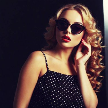 A beautiful blonde woman in a 60s vintage photo, wearing a polka dot dress and cat-eye sunglasses, looking glamorous clipart