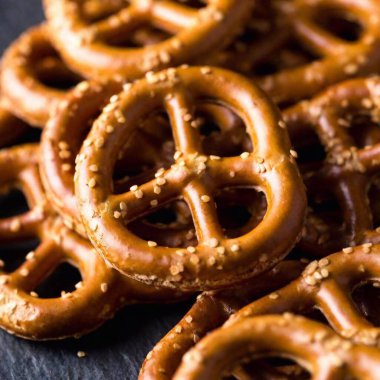 detailed macro shot of a pile of pretzels arranged on a table, taken from a low angle in a studio setting, with soft lighting and focus creating a cozy Oktoberfest ambiance clipart