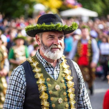 extreme macro portrait man on Munich Oktoberfest parade. The rack focus, with the festive background blurred at eye level. clipart