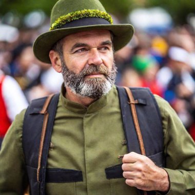 extreme macro portrait man on Munich Oktoberfest parade. The rack focus, with the festive background blurred at eye level. clipart