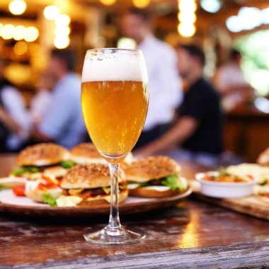 A close-up of a table with beer at the background Munich Oktoberfest celebrations. The focus is on the rich colors and textures of the food and drink, reflecting the culinary delights of the festival clipart