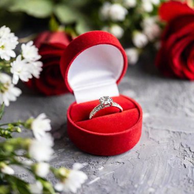 Close-up shot of a red velvet jewelry box, with the diamond ring inside in sharp focus and the soft velvet texture fading into the background, capturing the essence of a Valentine Day proposal. clipart