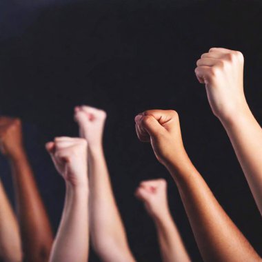 diverse group of women standing proudly, their arms raised with fist symbols, softly blurred to emphasize their determination and unity clipart