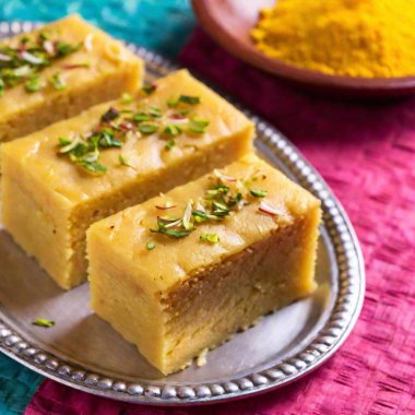 Traditional Diwali Food: A medium shot at eye level with rack focus in pop art style, focusing on the intricate layers of a Diwali dessert like soan papdi. The stylized texture and vibrant colors make the sweet look both traditional and trendy clipart