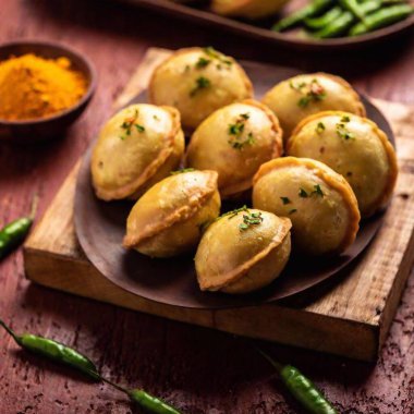 Traditional Diwali Food: An eye-level medium shot in Pop art style, using rack focus to emphasize a plate of traditional Diwali snacks like samosas and kachoris. The vivid colors and strong contrasts give the food an energetic and dynamic look clipart