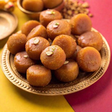 Traditional Diwali Food: An eye-level medium shot in Pop art style with rack focus, highlighting a decorative plate of traditional Diwali sweets like peda and gulab jamun. The bold colors and graphic elements give the food a lively and artistic feel. clipart