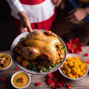 a closeup shot of a delicious thanksgiving day turkey with vegetables on the table clipart