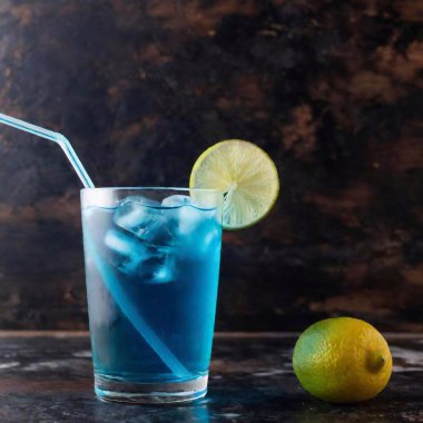 blue cocktail with lemon and ice cubes clipart