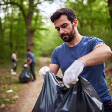 extreme Close-up portrait of a man tying up a full garbage bag after a successful Earth Day cleanup, with his hands and face in sharp focus and the background softly blurred, representing the completion of a meaningful task clipart