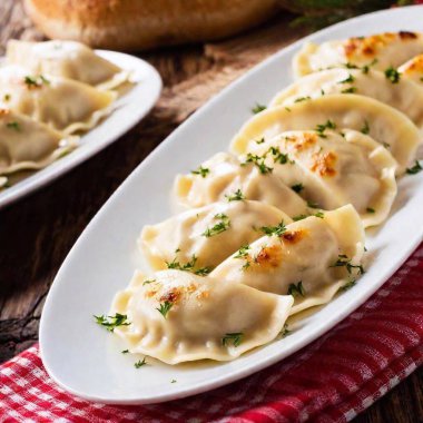 close up image of Mushroom and cabbage pierogi. Polish Christmas Eve dinner at eye level, focusing on meal clipart