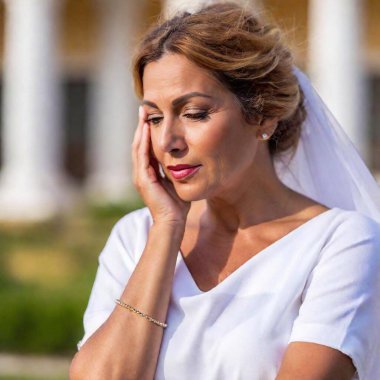 Penelope, a middle-aged Greek queen, dressed in white, without makeup, with brown hair and white locks, cries because she misses her husband Ulysses clipart