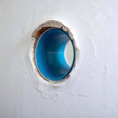 blue coating on the inner wall of a sewage pipe in a white wall clipart