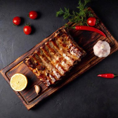 grilled ribs with spices and herbs on black background clipart