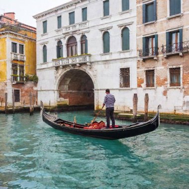 gondolier in gondola with venice canal clipart