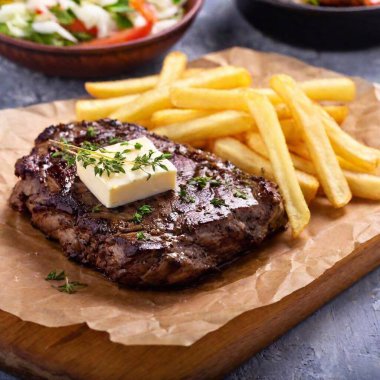 grilled steak on a wooden plate clipart