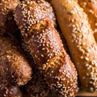 An extreme close-up of Polish Christmas Eve pastries, highlighting the texture and decoration of traditional sweets like pierniki (gingerbread) and makowiec (poppy seed roll) on a flatlay surface clipart