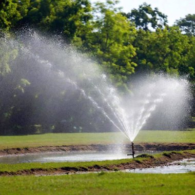 sprinkler in grass garden with water system clipart