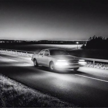 black and white drawing of a car driving along a highway at night in the style of Chris Van Allsburg clipart