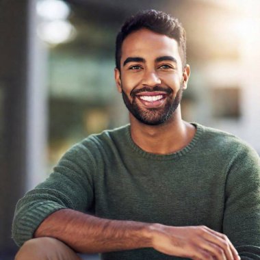 young hispanic man with beard smiling confident looking at the city park clipart