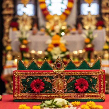 Generate a full shot of a festive altar for the Virgin of Guadalupe, captured at eye level with rack focus. Emphasize the ornate decorations and offerings in the foreground, with the background softly blurring into the distance clipart