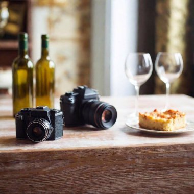 photo camera and wine on table clipart