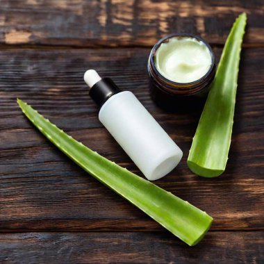 aloe vera and aloe vera gel on a wooden background. clipart