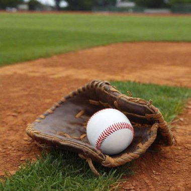 A baseball stadium with artificial turf and a baseball glove with a baseball sitting in the middle of it clipart